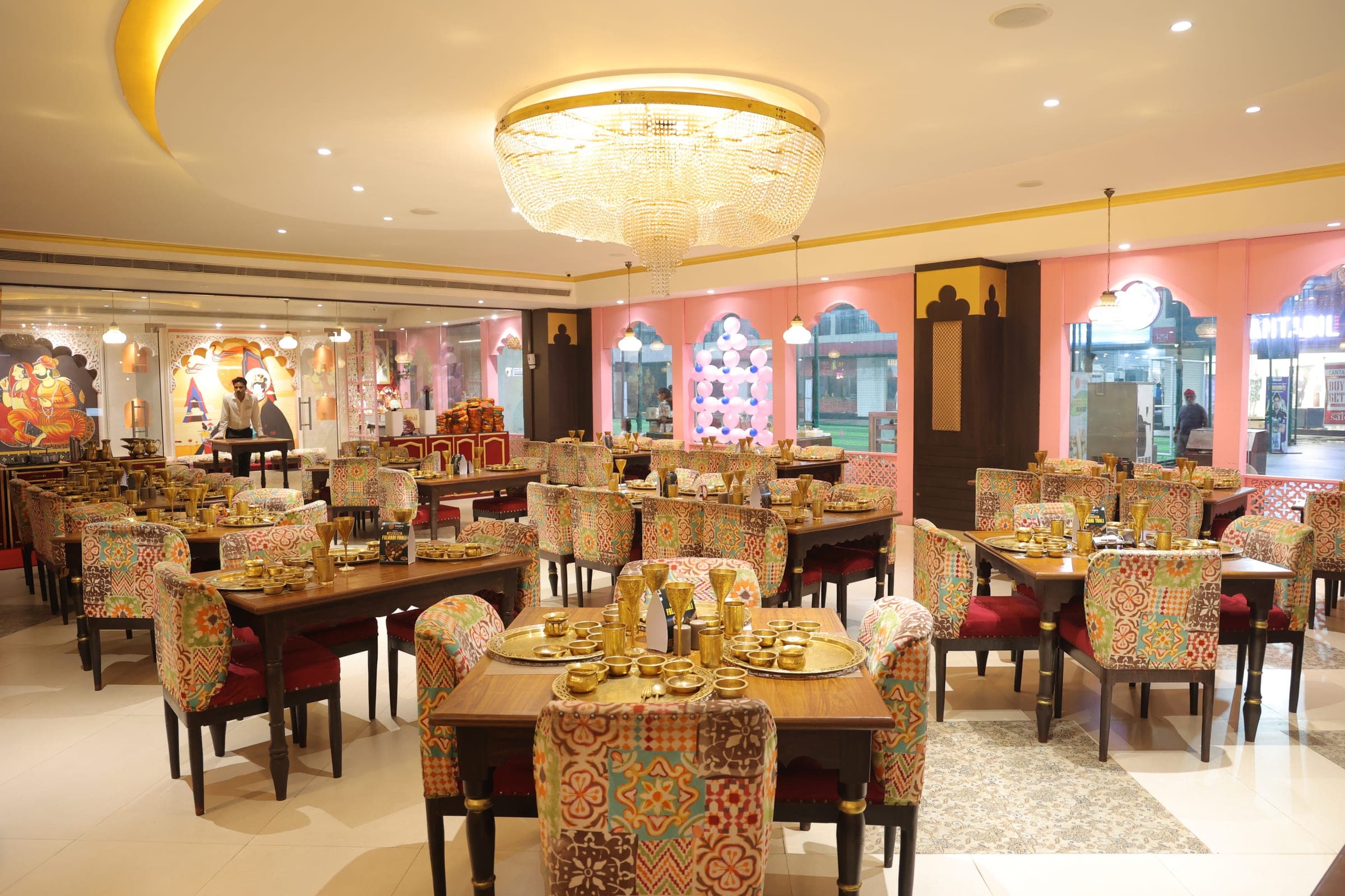 Grand dining hall at Banjara Sonari with chandelier and patterned seating