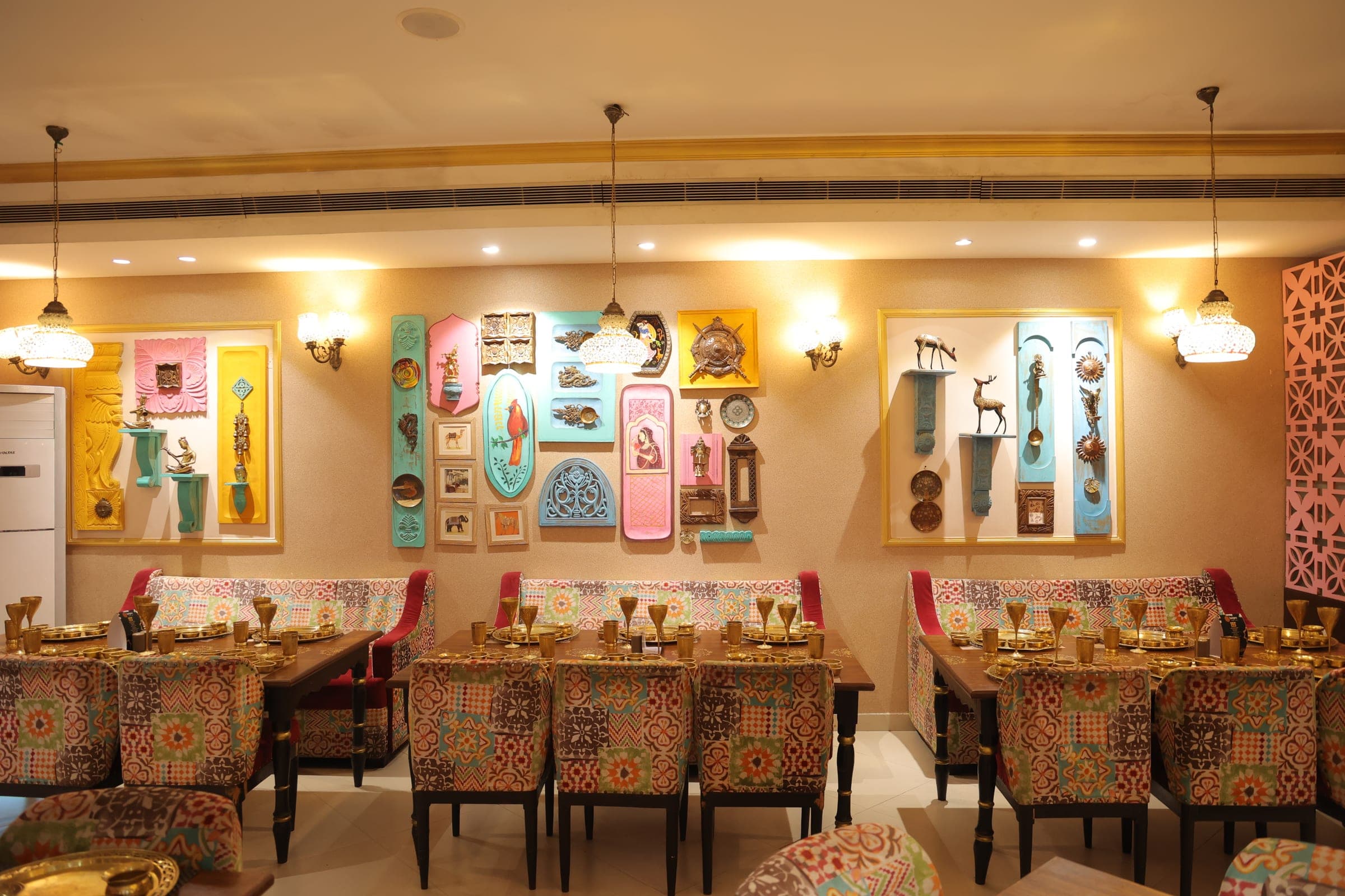 Decorative Indian wall art and patterned seating inside Banjara